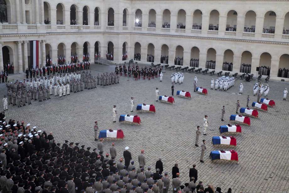 Coffins of 13 French soldiers killed in Mali lay at the Invalides monument during a ceremony Monday Dec.2, 2019 in Paris. In its biggest military funeral in decades