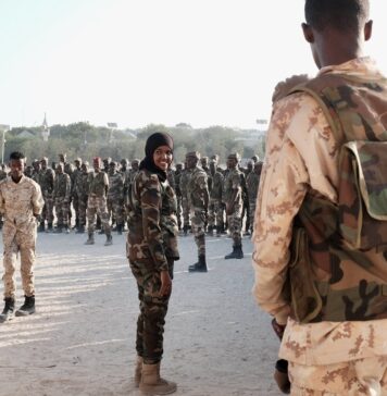 Lt. Col. Iman Elman, who is in charge of planning for the Somali National Army, overseeing troops before their deployment in anti-Shabab operations.Credit...Luca Bucken